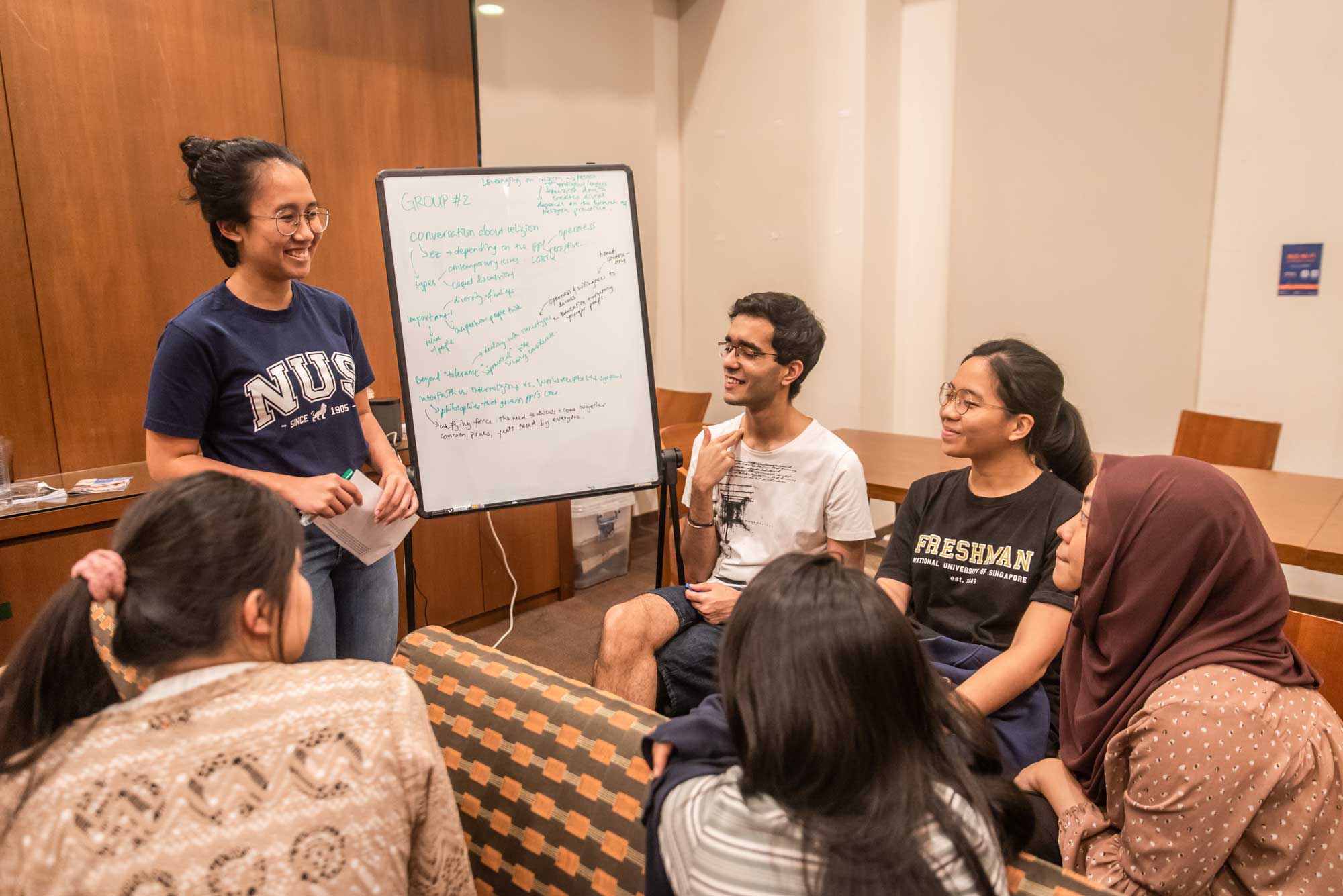 Students break out into smaller groups to discuss on the topic.