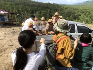 Local Primary School students travelling via pickup truck to plant the King's Grass on different hills to stabilise the new Irrigation System